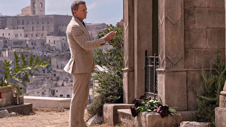 Daniel Craig as James Bond standing by the tomb of his lover Vesper Lynd in No Time To Die