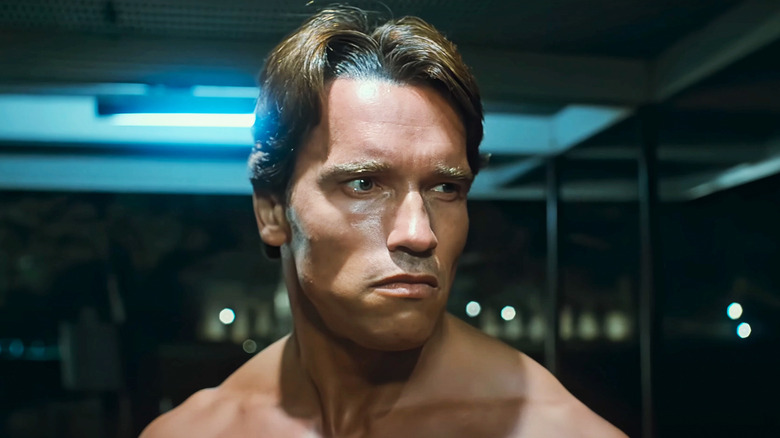 Arnold Schwarzenegger's Terminator stands in a bus stop in The Terminator