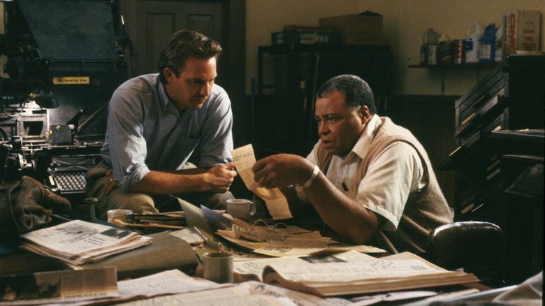 Terence Mann and Ray Kinsella look through old newspapers in Field of Dreams.