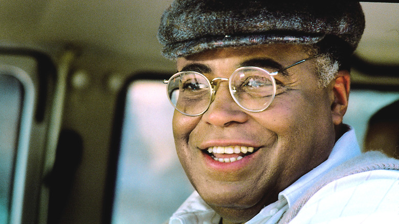 Terence Mann smiling in a hat and glasses in Field of Dreams