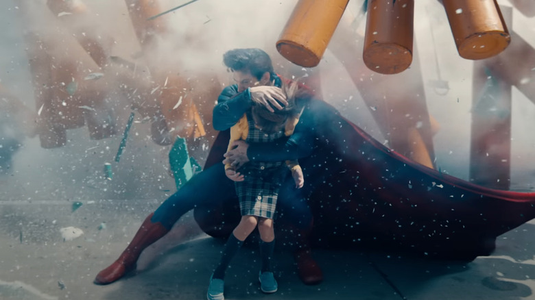 David Corenswet's Superman saving a little girl from debris in Superman (2025)