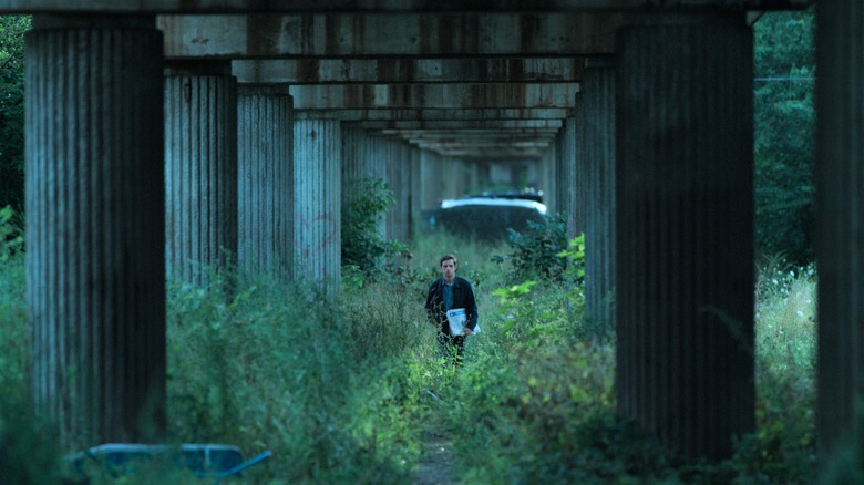 Jamie Bell under a bridge