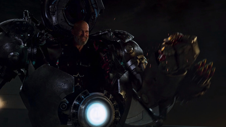 Obadiah Stane smiling and crushing Tony Stark's helmet in Iron Man