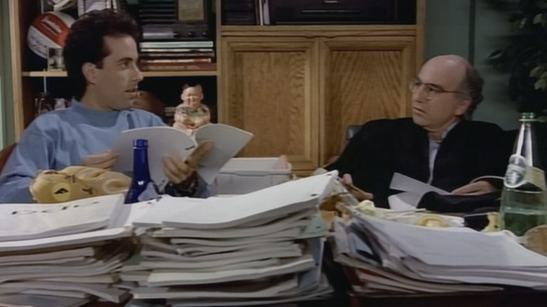 Jerry Seinfeld and Larry David Wade through a pile of scripts in love and war