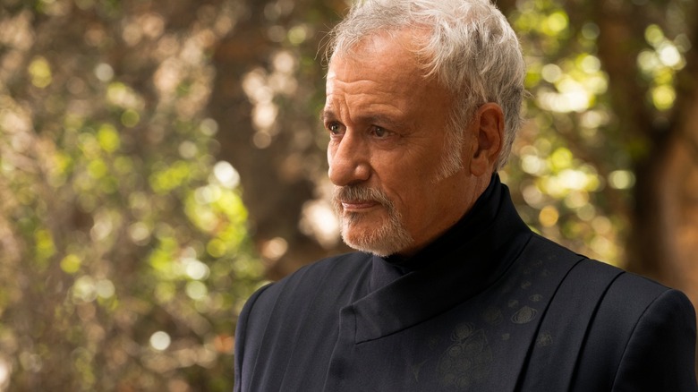 Q, looking older, standing out in the woods on Star Trek: Picard