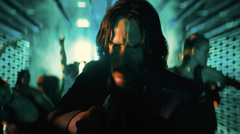 John Wick Chapter 4 john stalking with gun through club