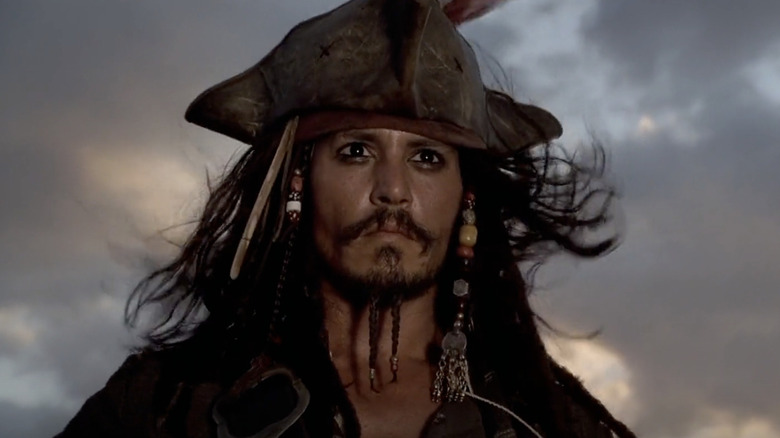 Johnny Depp's Captain Jack Sparrow wearing a hat in Pirates of the Caribbean: The Curse of the Black Pearl