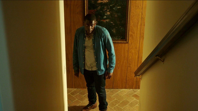Daniel Kaluuya looks up the stairs in Get Out