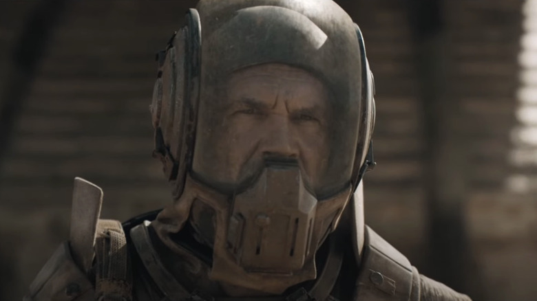 Josh Brolin as Gurney Halleck wears a helmet outside on Arrakis in Dune