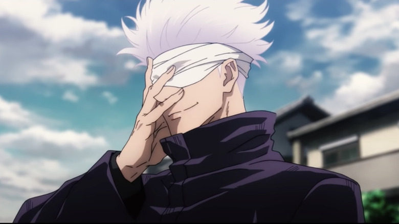 Satoru Gojo covers his face with his hand as he smiles in Jujutsu Kaisen 0