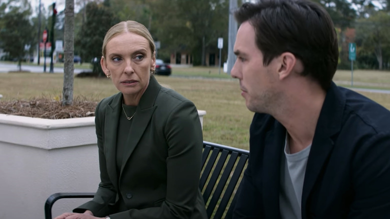 Nicholas Hoult's Justin Kemp sits on a bench next to Toni Collette's Faith Killebrew in Juror #2