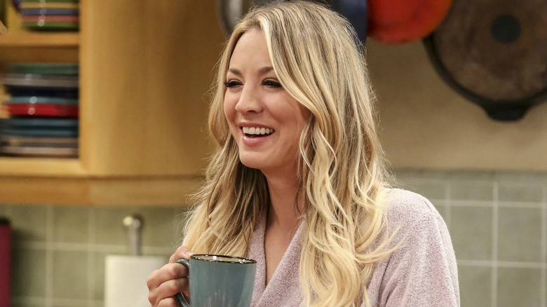 Penny laughing and holding a coffee cup on The Big Bang Theory