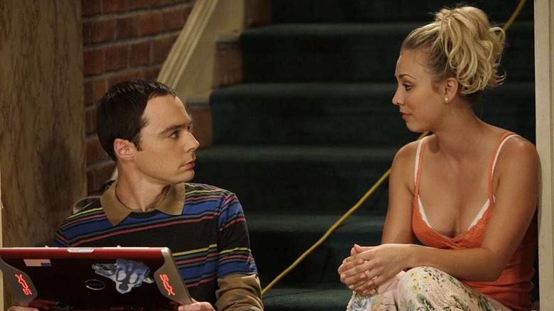 Sheldon and Penny talking and sitting on the stairs in The Big Bang Theory