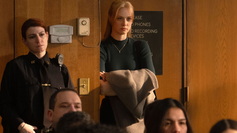 Deborah Ann Woll as Karen Page standing at the back of a courtroom in Daredevil: Born Again