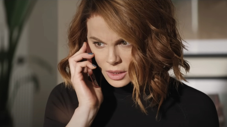 Avery Graves looks concerned as she takes a call on her cell phone in Canary Black