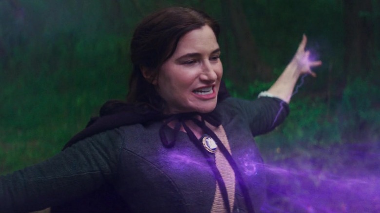 Kathryn Hahn as Agatha Harkness, absorbing purple energy in the woods in Agatha All Along