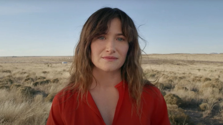 Kathryn Hahn as Chris Krause standing in a field of grass in I Love Dick