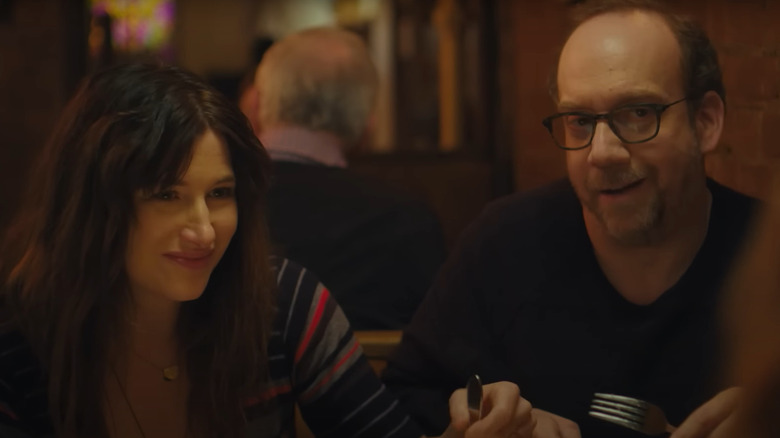 Kathryn Hahn and Paul Giamatti as Rachel and Richard Biegler at dinner with someone in Private Life