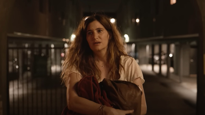 Kathryn Hahn as Claire Kinkade, standing in the middle of a street at night in Tiny Beautiful Things