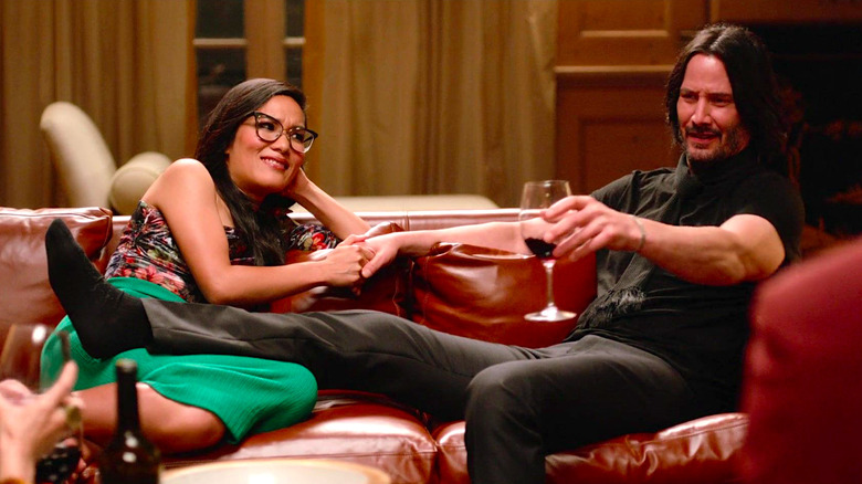 Ali Wong and Keanu Reeves relax on a couch in Always Be My Maybe