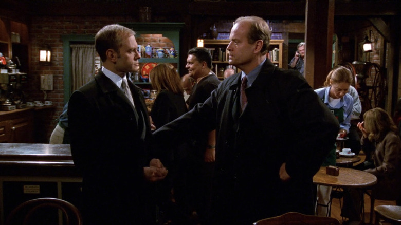 Kelsey Grammer's Frasier Crane and David Hyde Pierce's Niles Crane stand facing each other in Cafe Nervosa in Frasier