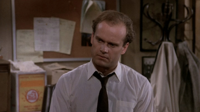 Frasier sits in Cheers bar looking concerned in Cheers