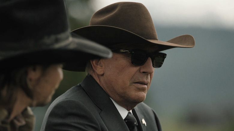 Kevin Costner looks somber behind dark sunglasses as John Dutton in Yellowstone