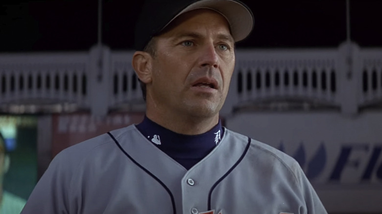 Billy Chapel in a baseball uniform with a dark sky in the background