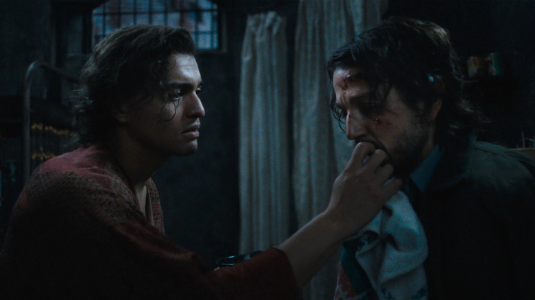 Molina tends to Valentin's wound in Kiss of the Spider Woman