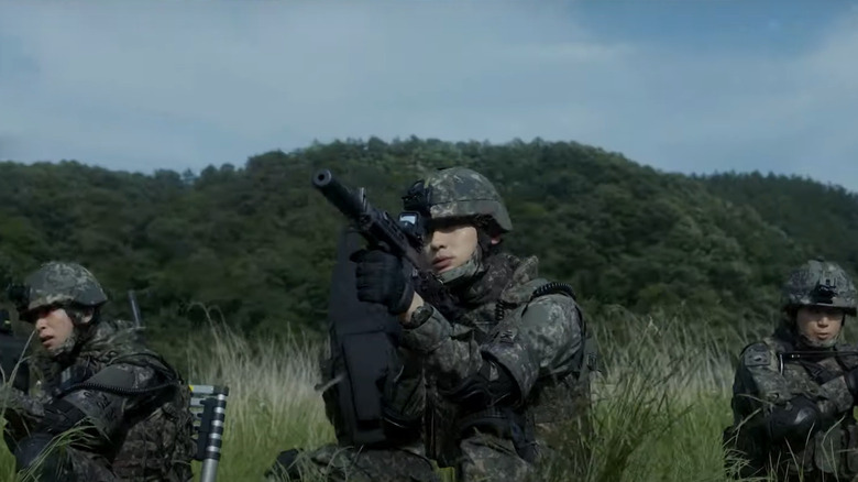 Soldiers pointing guns