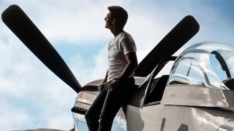 Tom Cruise next to plane in Top Gun: Maverick