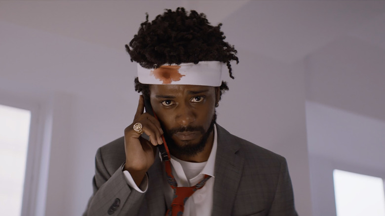 Wounded Cash on phone in Sorry to Bother You