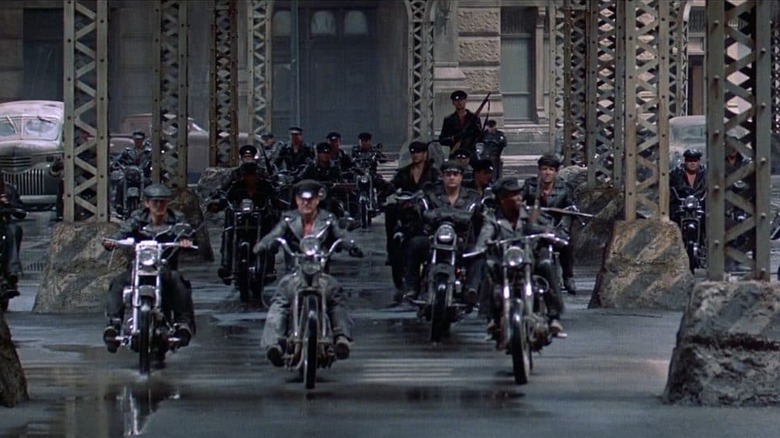 A motorcycle gang is riding to the city in the streets of fire