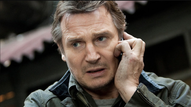 Liam Neeson as Bryan Mills smirking in the kitchen in Tak3n