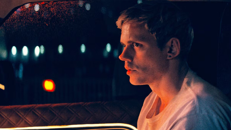 Bill Skarsgard's Eddie sitting in the car while wearing a white t-shirt in Locked