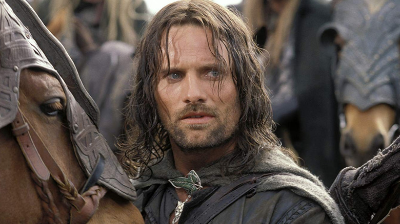 Aragorn looking concerned next to his horse