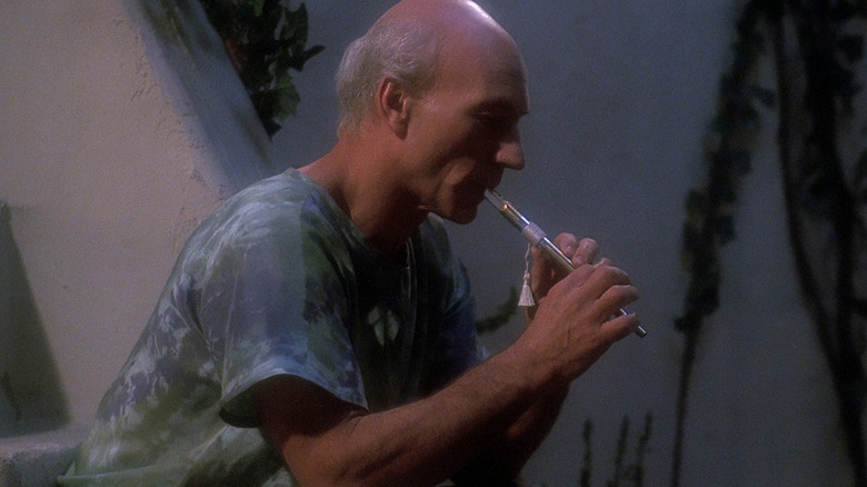 Patrick Stewart as Captain Picard playing a flute in Star Trek: The Next Generation