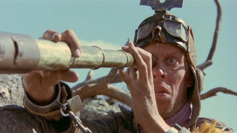 Mad Max 2 gyro captain looks in telescope