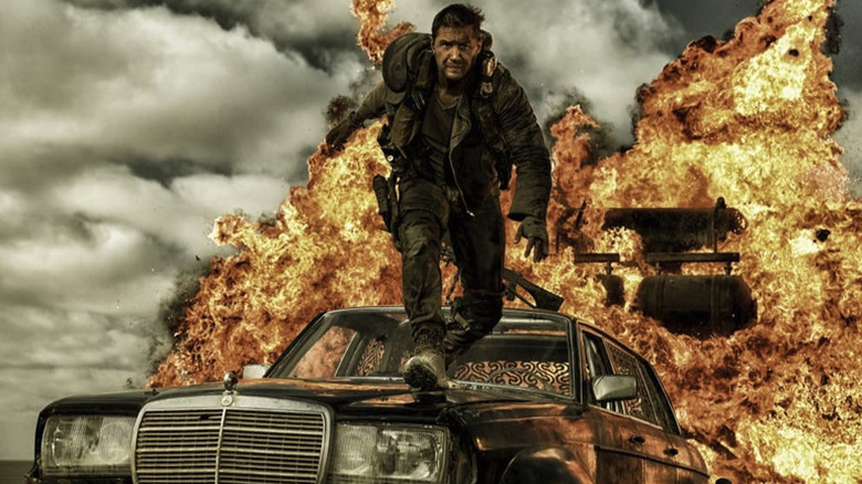 Tom Hardy about to jump away from an explosion