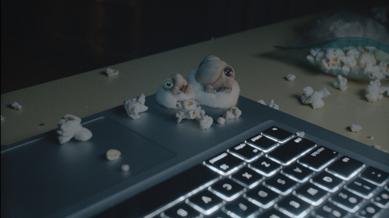 marcel the shell and nannie connie watching tv on a laptop surrounded by popcorn