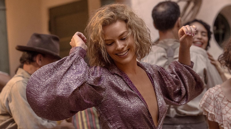 Margot Robbie as Nellie LaRoy dancing happily in Babylon