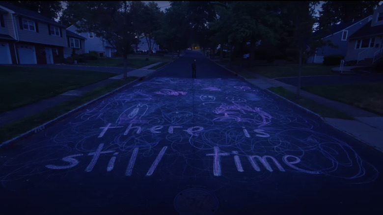 Chalk writing is seen on dark street in I Saw the TV Glow