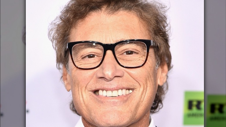 Steven Bauer in glasses smiling