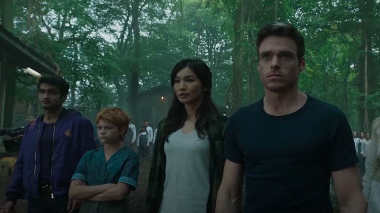 The Eternals in civilian clothes in a forest