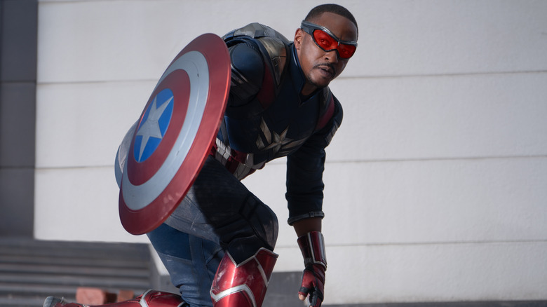 Anthony Mackie as Sam Wilson holding Cap's shield in a squat in Captain America: Brave New World