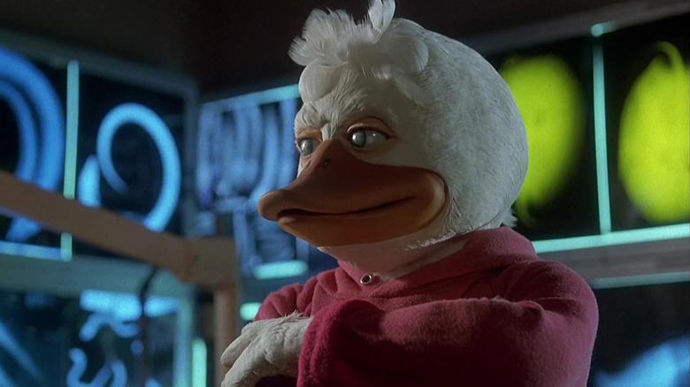 Howard the Duck in a red hoodie, standing taciturn in front of some neon lights. From Howard the Duck.