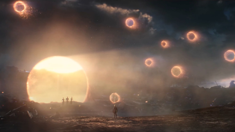 Steve Rogers faces a wall of opening portals