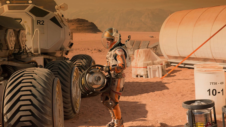 Matt Damon carrying canister The Martian