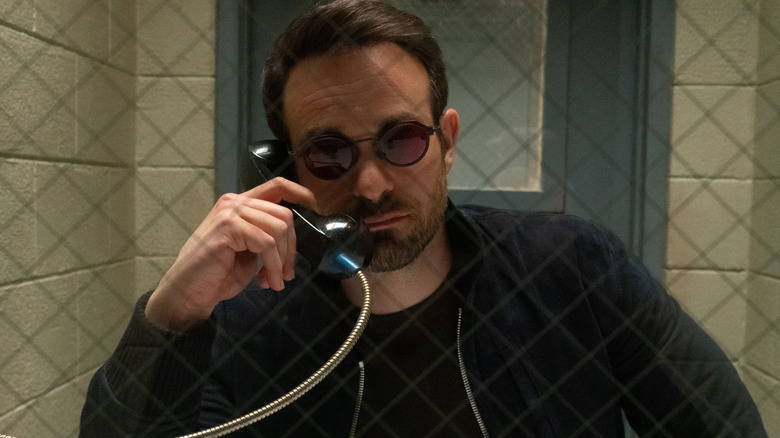 Charlie Cox's Matt Murdock holding a prison phone in Daredevil: Born Again