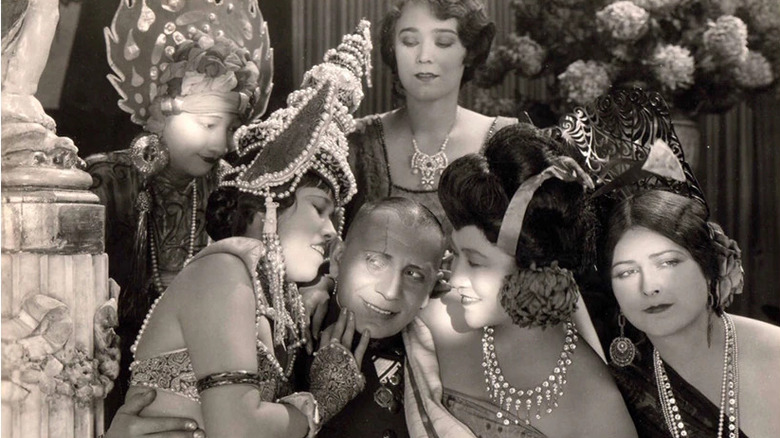 Elena Jurado and her co-stars fawning over Erich von Stroheim in "The Wedding March"